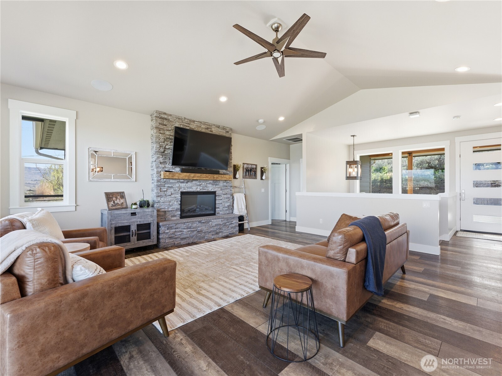2128 McEldowney Road Malaga, WA 98828 - Photo 8 of 39 a living room with furniture a fireplace and a flat screen tv