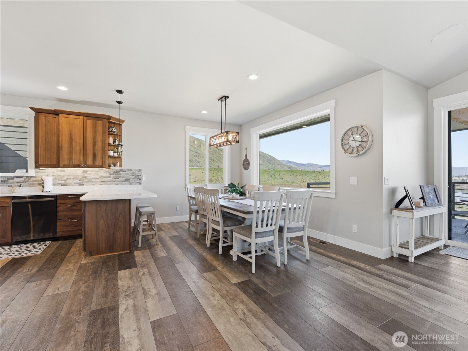 2128 McEldowney Road Malaga, WA 98828 - Photo 10 of 39 a dining room with a wooden floor and chandelier