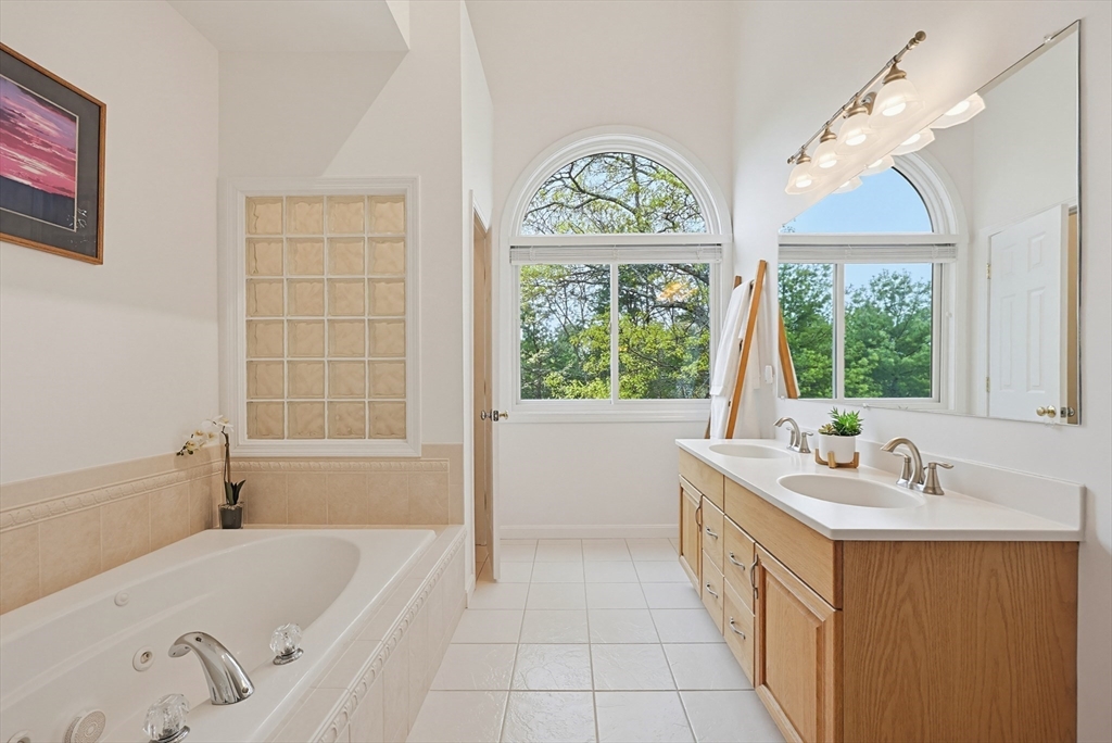 3002 Maple Brook Road, Unit 3002 Bellingham, MA 02019 - Photo 22 of 42 a bathroom with a tub sink and window