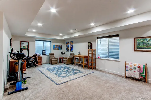 a living room with furniture a air conditioner vent and a window