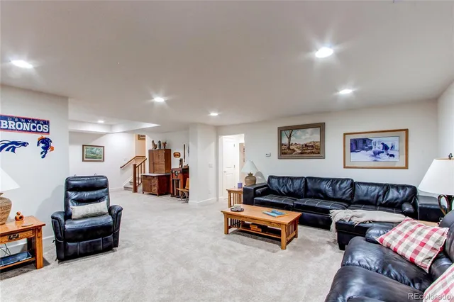 a bedroom with a bed couch and a window