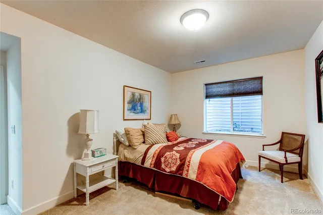 a bedroom with bed and a flat screen tv