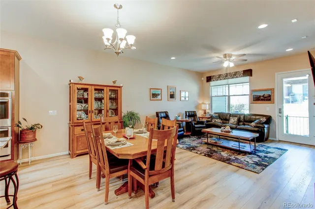a living room with furniture a window and wooden floor