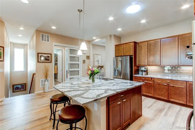 a view of a dining room with furniture a chandelier and wooden floor