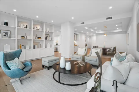 a living room with furniture kitchen and a table