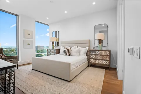 a bedroom with a large bed and a night stand