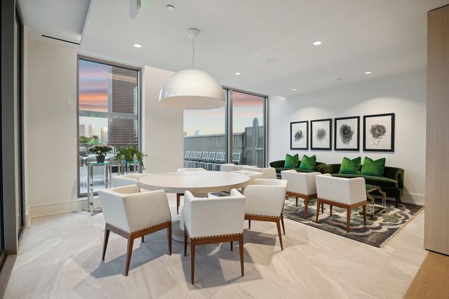 a dining room with furniture a chandelier and wooden floor