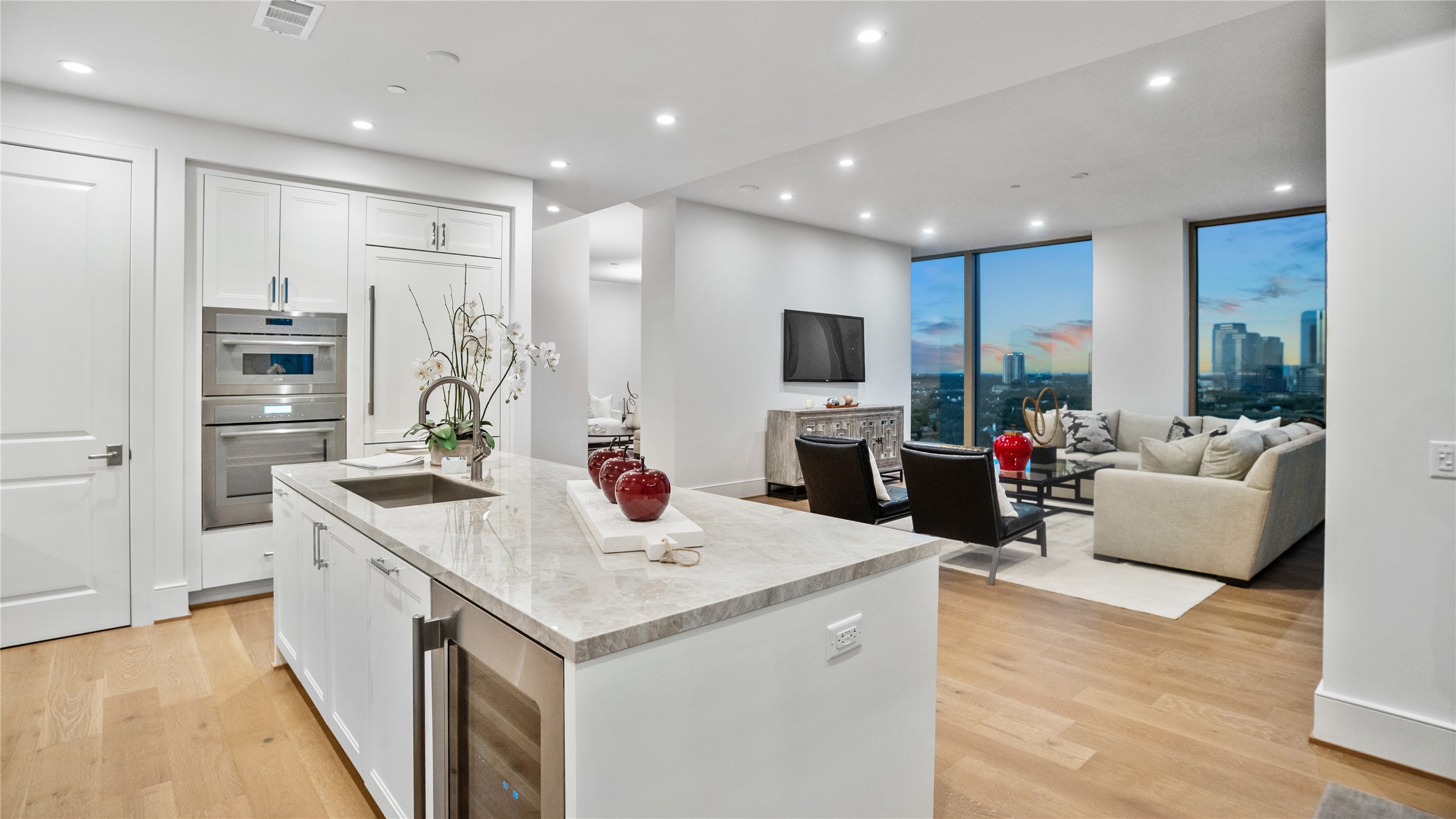 5656 San Felipe Street, Unit 1301 Houston, TX 77056 - Photo 4 of 30 a open kitchen with stainless steel appliances kitchen island granite countertop a refrigerator a sink dishwasher and a flat screen tv