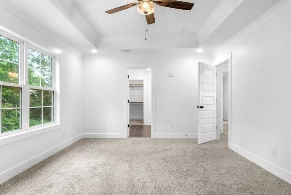 an empty room with windows and cabinet
