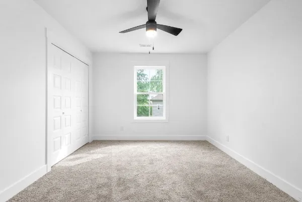 a view of room with window and ceiling fan