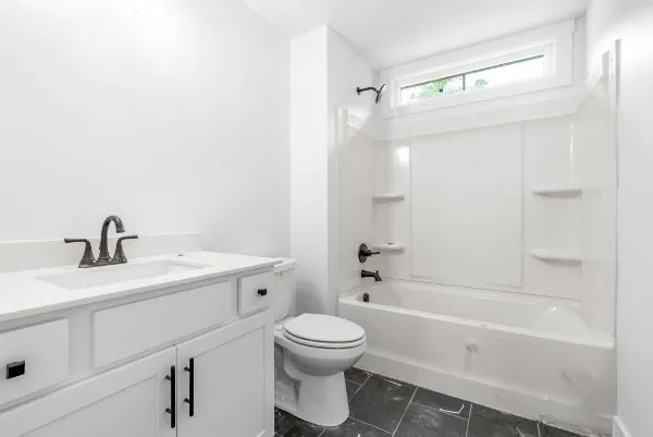 a bathroom with a toilet a sink and a bathtub