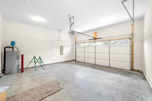a front view of a house with a garden and garage