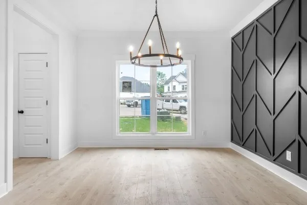 an empty room with windows and entrance