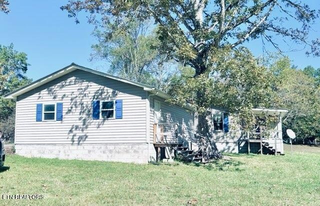 1830 Buffalo Road Oneida, TN 37841 - Photo 5 of 16 a front view of a house with a yard