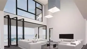 a living room with furniture and a floor to ceiling window