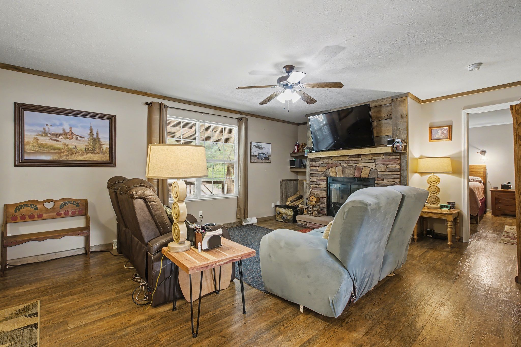10878 Highway 7 Primm Springs, TN 38476 - Photo 18 of 37 a living room with furniture fireplace and a flat screen tv