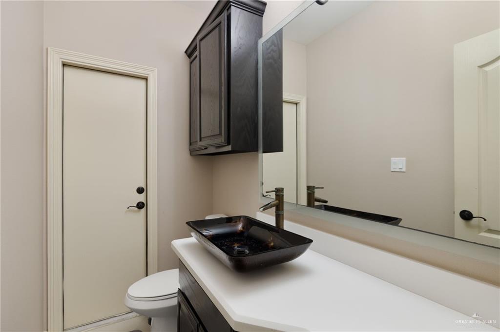 1202 Hummingbird Drive Pharr, TX 78577 - Photo 11 of 23 a bathroom with a sink a toilet and shower
