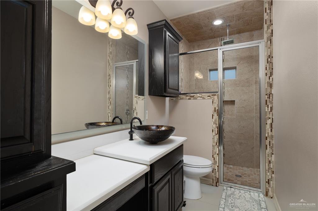 1202 Hummingbird Drive Pharr, TX 78577 - Photo 14 of 23 a bathroom with a double vanity sink toilet and shower