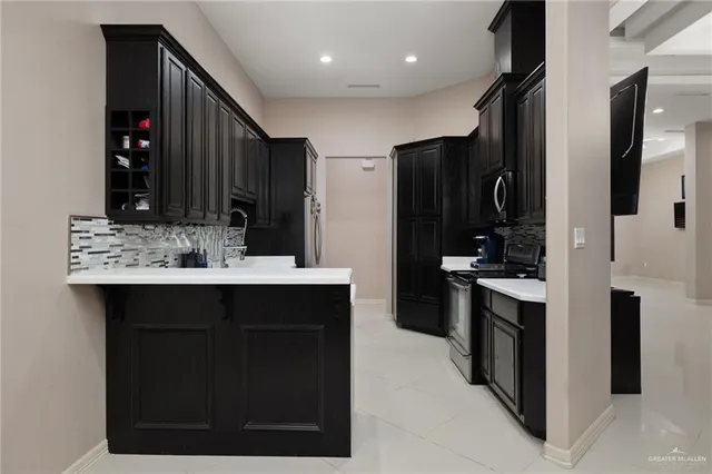 a kitchen with stainless steel appliances a sink stove and refrigerator