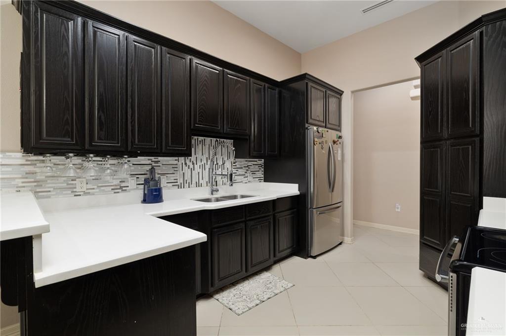 1202 Hummingbird Drive Pharr, TX 78577 - Photo 7 of 23 a kitchen with a sink and cabinets