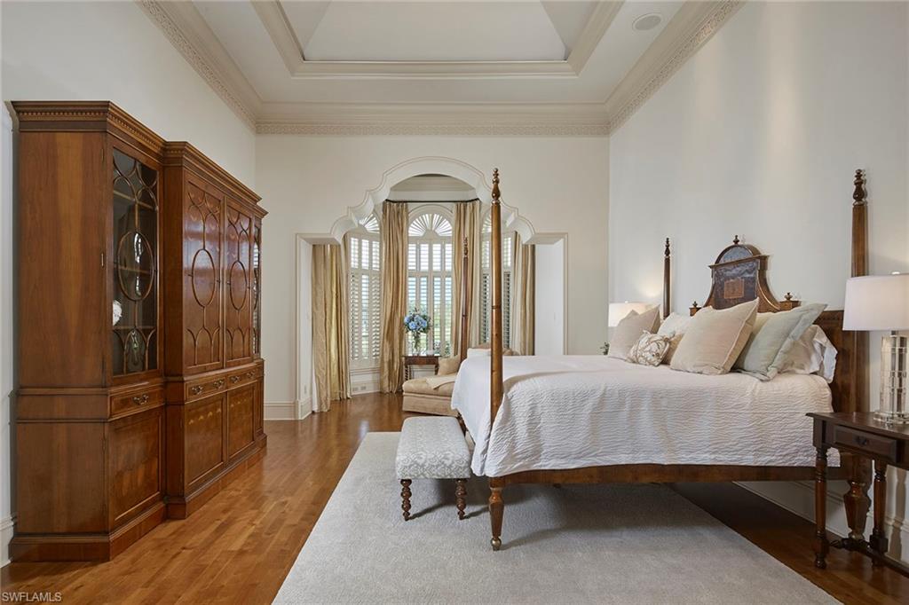 1397 Great Egret Trail Naples, FL 34105 - Photo 20 of 50 a spacious bedroom with a bed and a refrigerator