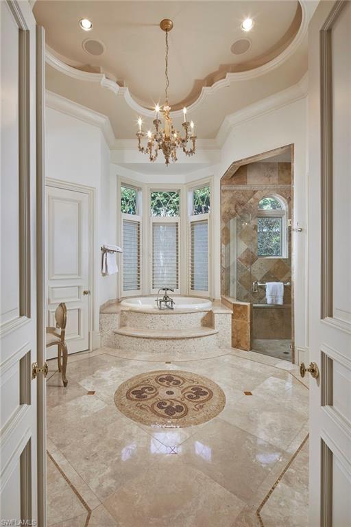 1397 Great Egret Trail Naples, FL 34105 - Photo 21 of 50 a view of a kitchen with granite countertop cabinets and a chandelier