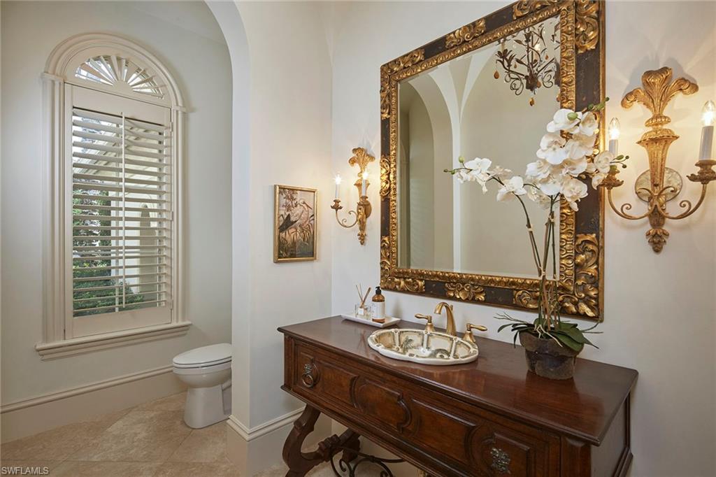 1397 Great Egret Trail Naples, FL 34105 - Photo 26 of 50 a bathroom with a granite countertop sink a toilet and a mirror