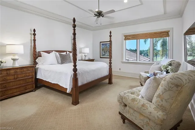 a bedroom with a bed lamp and window