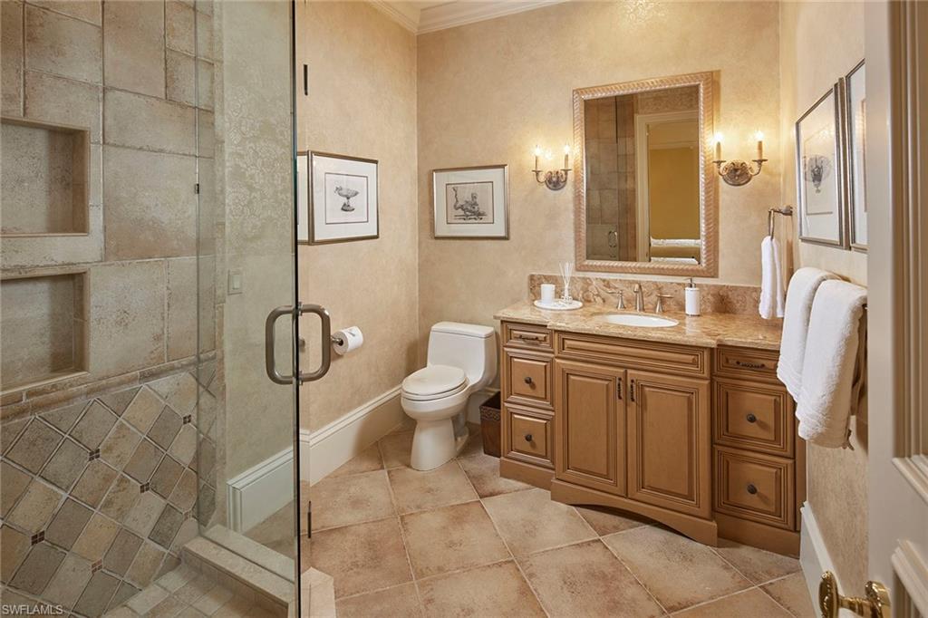 1397 Great Egret Trail Naples, FL 34105 - Photo 33 of 50 a spacious bathroom with a toilet sink and mirror