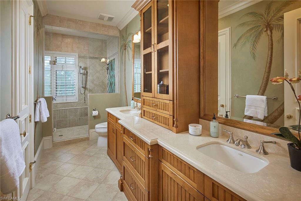 1397 Great Egret Trail Naples, FL 34105 - Photo 35 of 50 a bathroom with a granite countertop double vanity sink a mirror and a shower