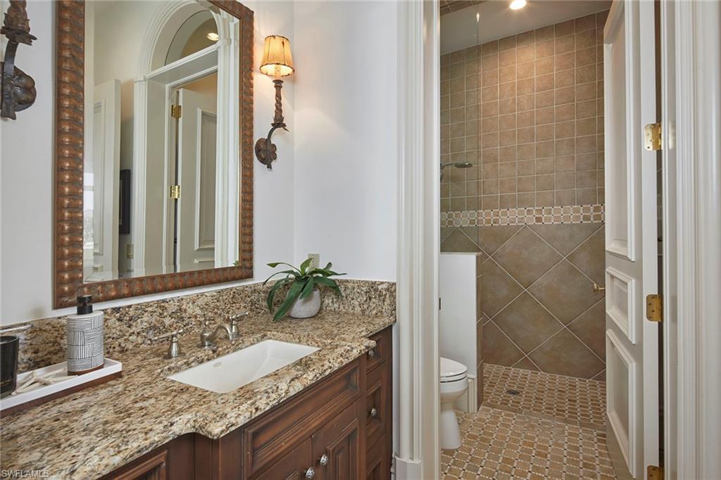 1397 Great Egret Trail Naples, FL 34105 - Photo 38 of 50 a bathroom with a granite countertop sink and a mirror