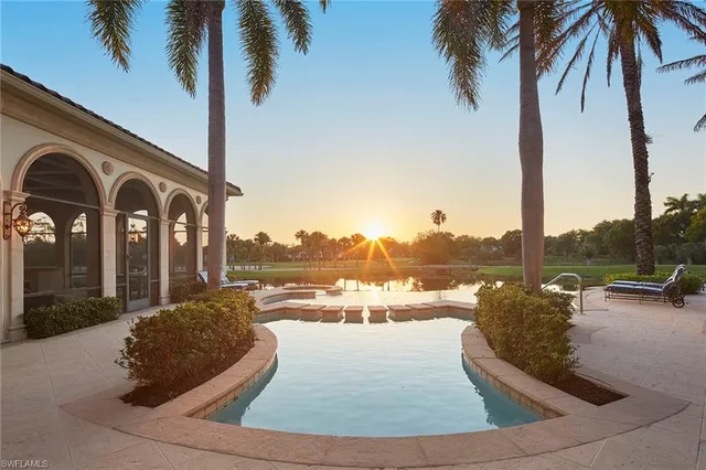 a view of a house with a swimming pool and a yard