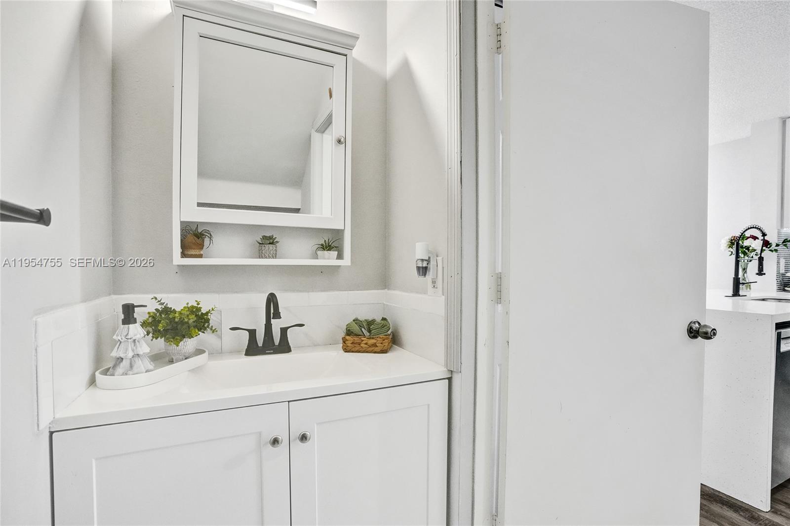 5361 Southwest 125th Avenue Miramar, FL 33027 - Photo 13 of 38 a bathroom with a sink and a mirror