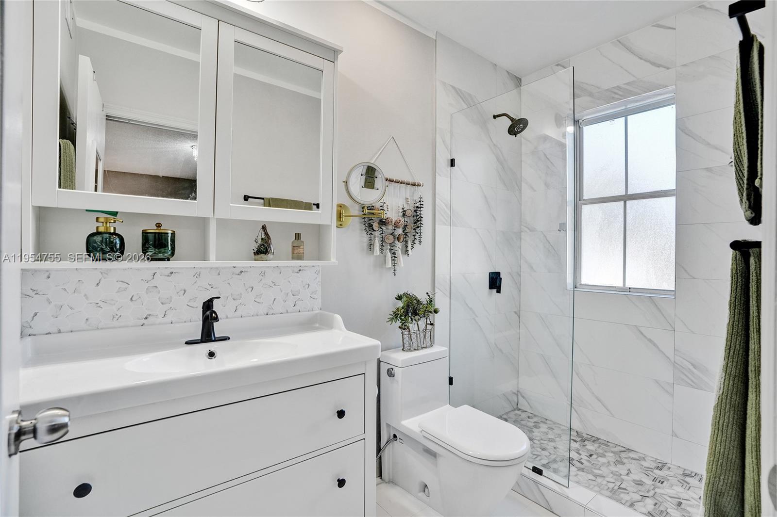 5361 Southwest 125th Avenue Miramar, FL 33027 - Photo 14 of 38 a bathroom with a sink a toilet and shower