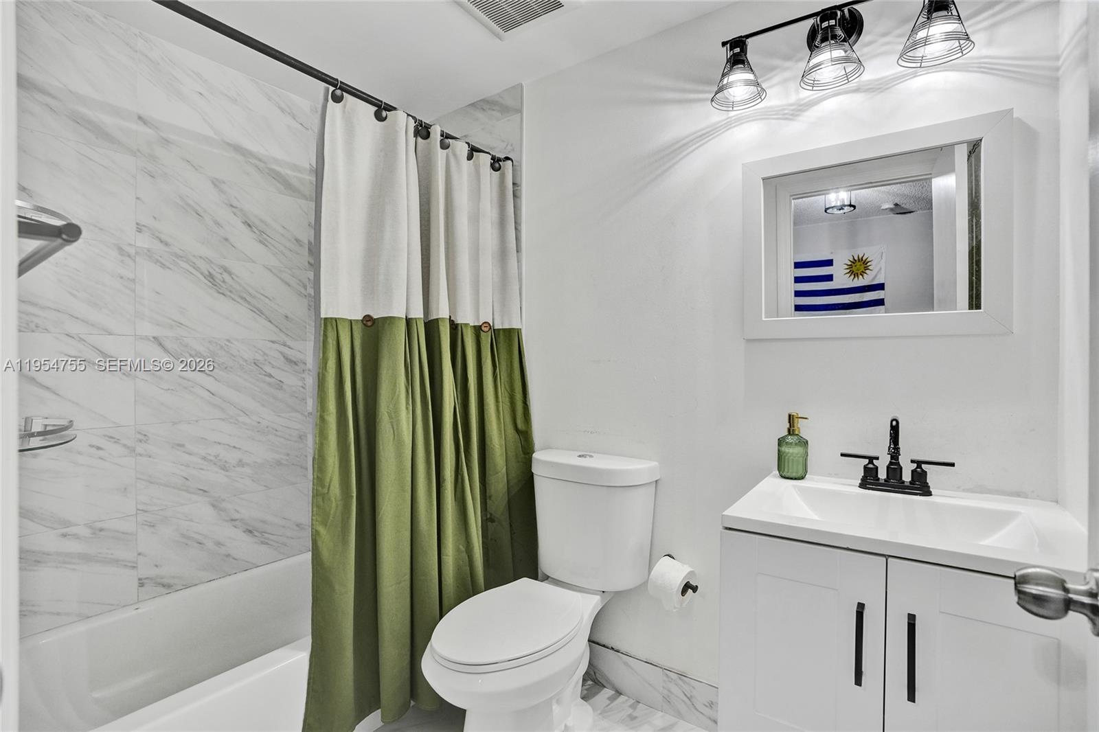 5361 Southwest 125th Avenue Miramar, FL 33027 - Photo 19 of 38 a bathroom with a toilet sink and mirror