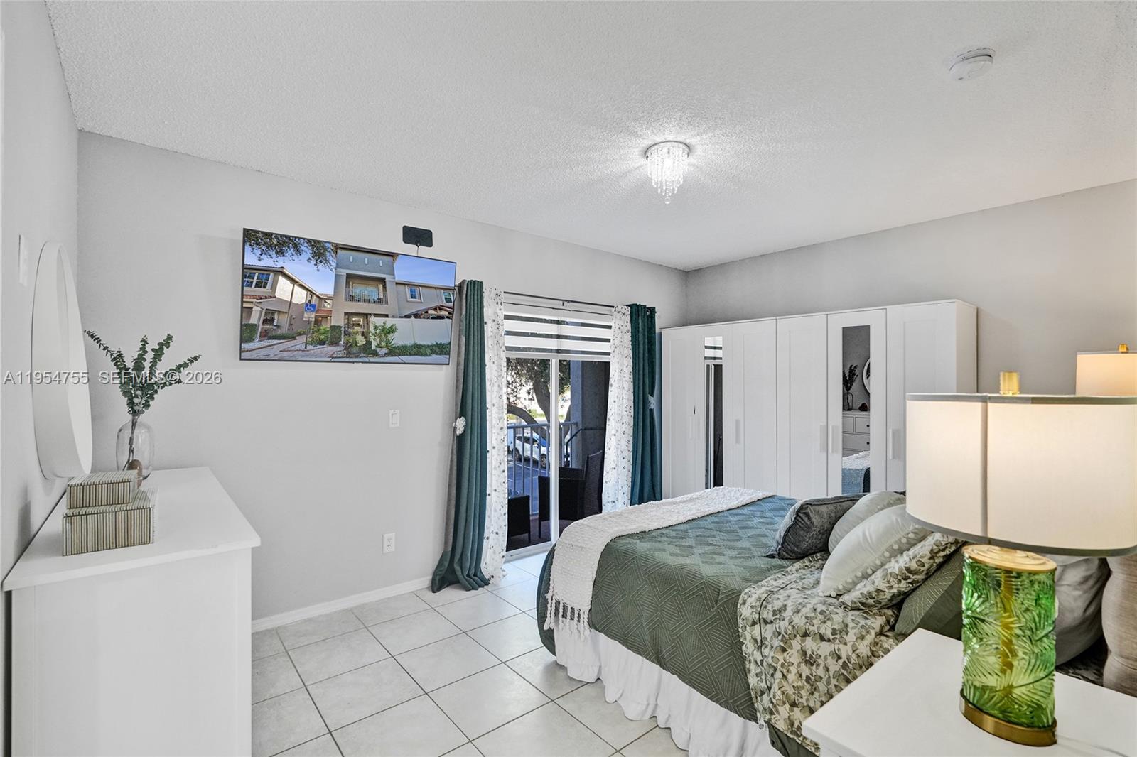 5361 Southwest 125th Avenue Miramar, FL 33027 - Photo 3 of 38 a bedroom with a bed and a table