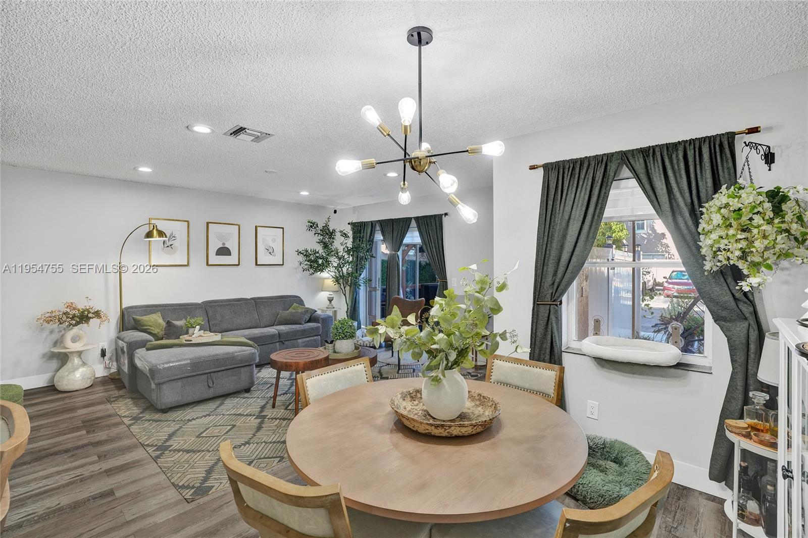 5361 Southwest 125th Avenue Miramar, FL 33027 - Photo 10 of 38 a living room with furniture and a potted plant