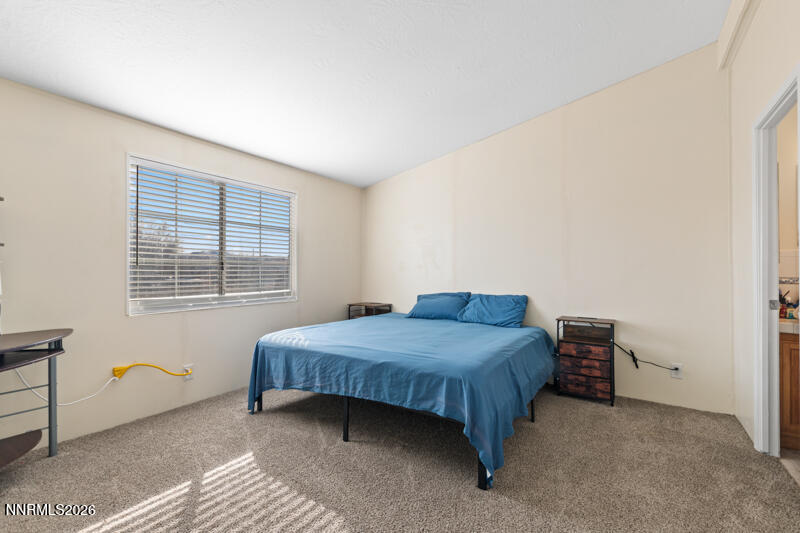 2575 Tonopah Street Silver Springs, NV 89429 - Photo 11 of 22 a bedroom with a bed and a window
