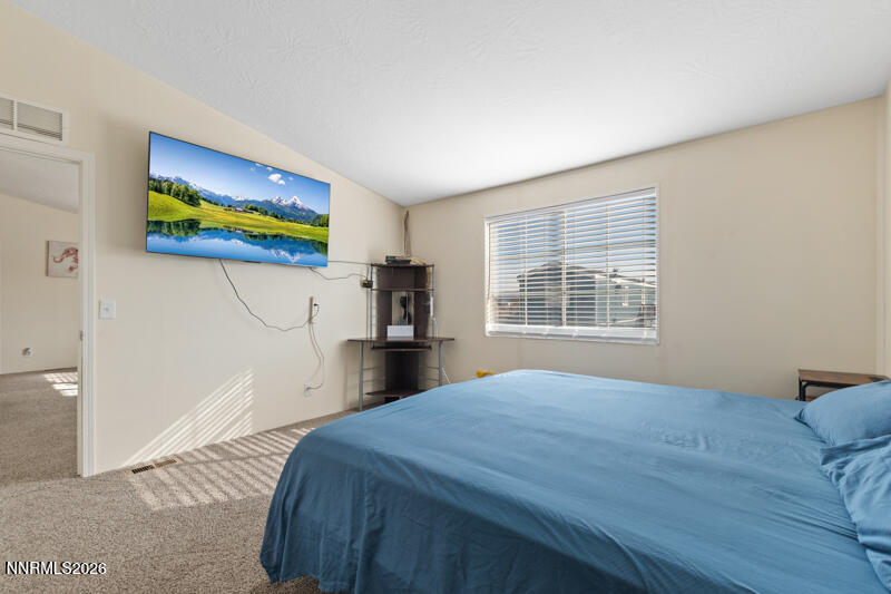 2575 Tonopah Street Silver Springs, NV 89429 - Photo 12 of 22 a bedroom with a bed and a window