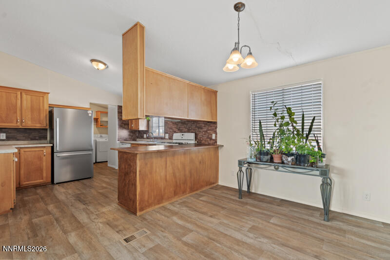 2575 Tonopah Street Silver Springs, NV 89429 - Photo 7 of 22 a kitchen with refrigerator and cabinets