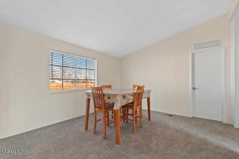 2575 Tonopah Street Silver Springs, NV 89429 - Photo 10 of 22 a view of a dining room with furniture and chandelier
