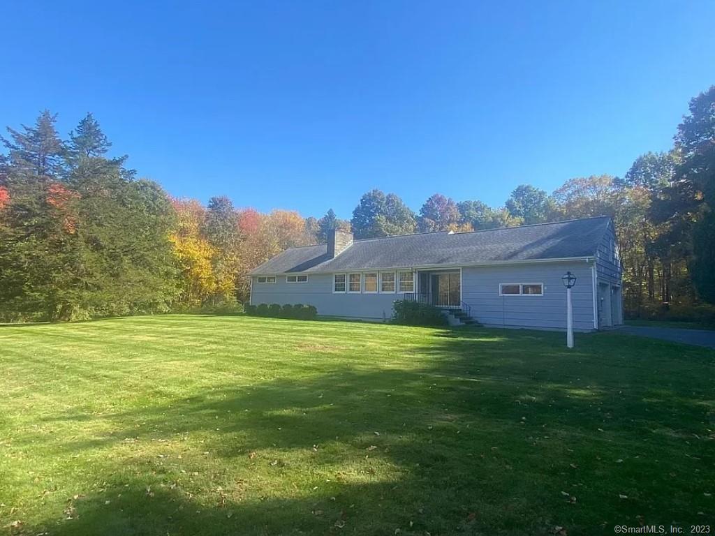a view of a big yard with a house in the background