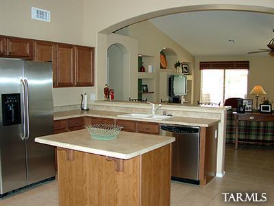 62195 East Northwood Road Tucson, AZ 85739 - Photo 11 of 25 a kitchen with stainless steel appliances granite countertop a sink a oven and a refrigerator
