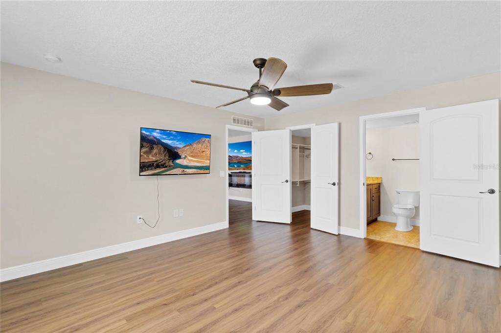 1705 Ridgemoor Drive Mascotte, FL 34753 - Photo 14 of 53 a view of a big room with wooden floor and a ceiling fan