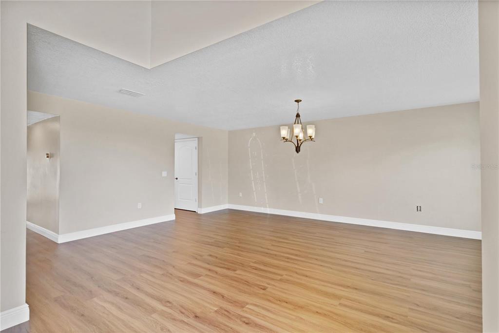 1705 Ridgemoor Drive Mascotte, FL 34753 - Photo 3 of 53 wooden floor in an empty room with a window