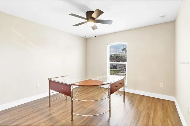 a room with table and ceiling fan