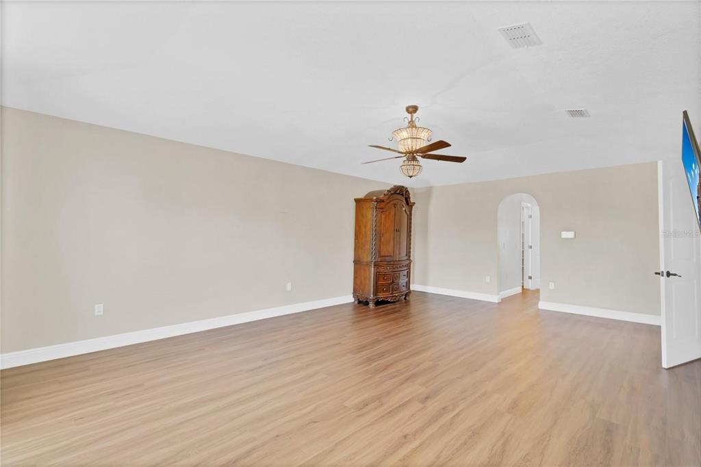 1705 Ridgemoor Drive Mascotte, FL 34753 - Photo 35 of 53 an empty room with wooden floor and ceiling fan