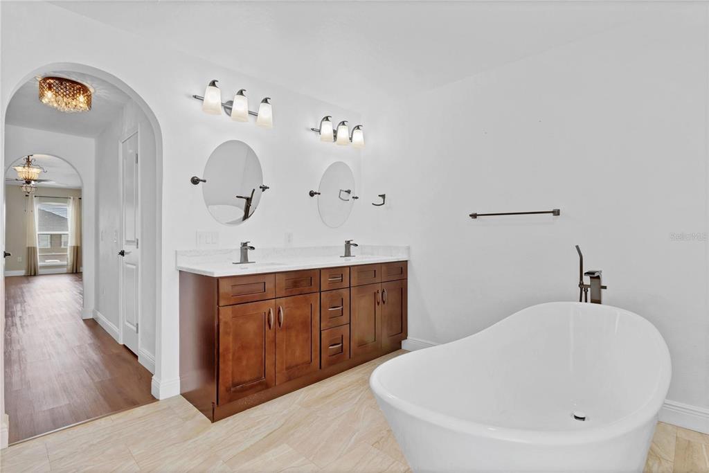 1705 Ridgemoor Drive Mascotte, FL 34753 - Photo 39 of 53 a spacious bathroom with a double vanity sink and a mirror
