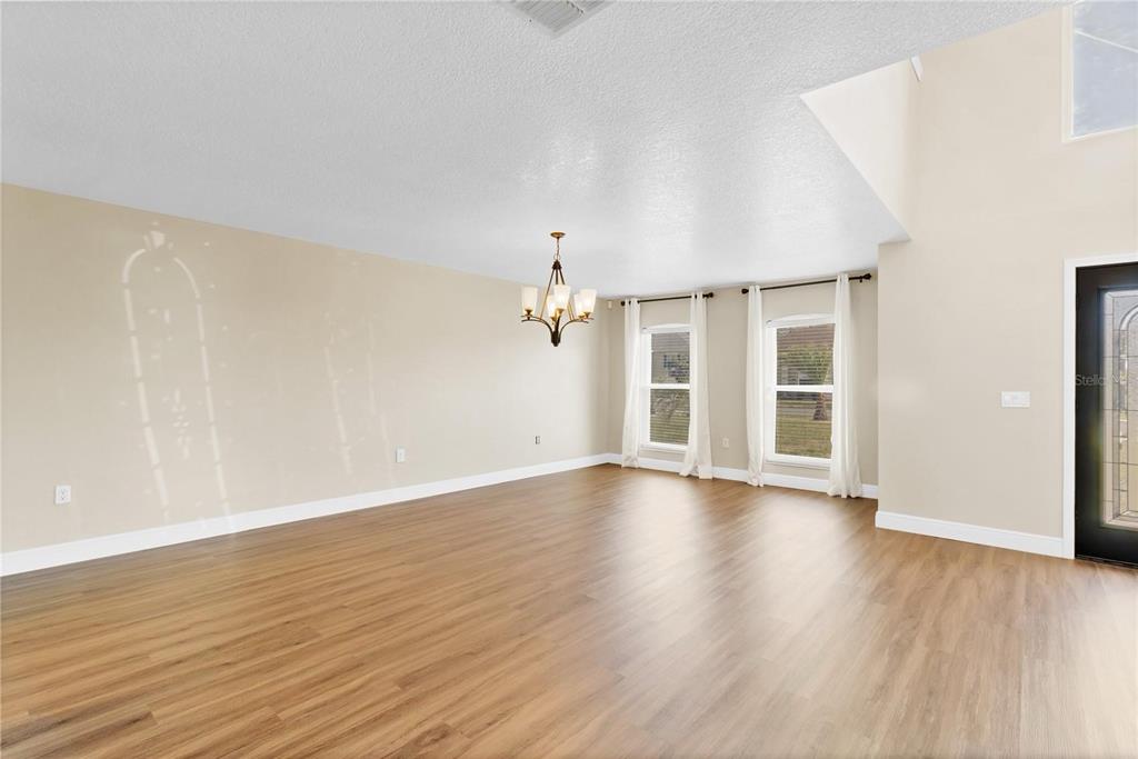 1705 Ridgemoor Drive Mascotte, FL 34753 - Photo 4 of 53 wooden floor in an empty room with a window