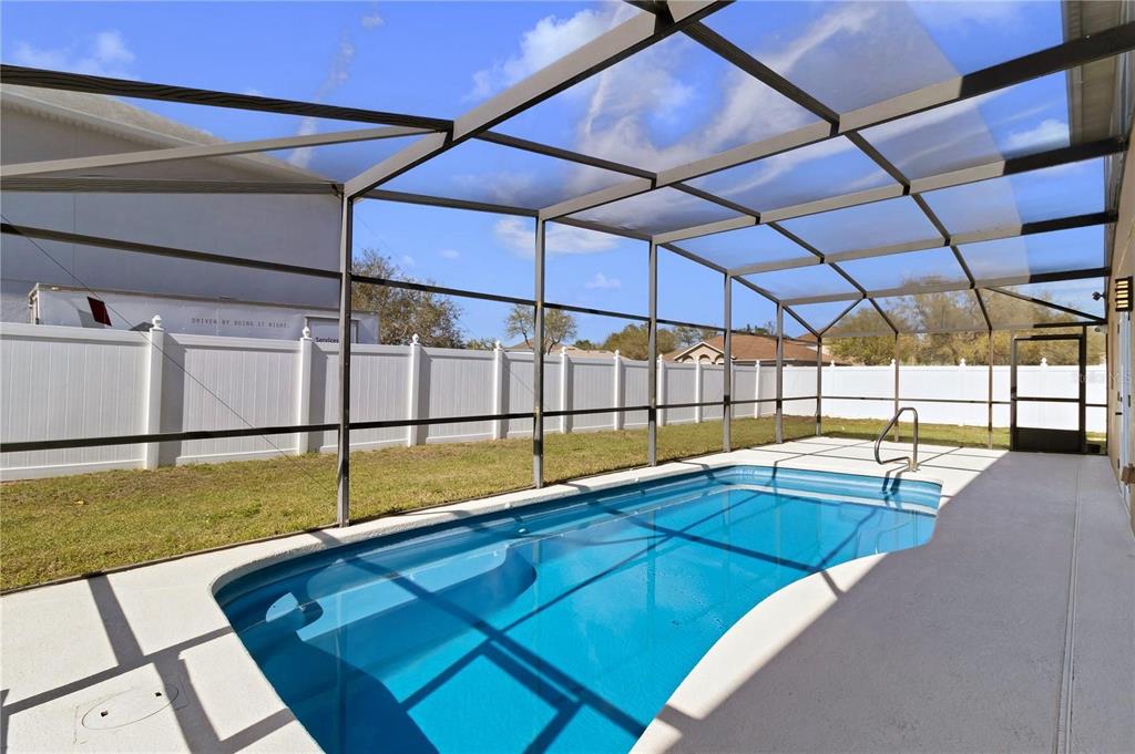 1705 Ridgemoor Drive Mascotte, FL 34753 - Photo 46 of 53 a view of a swimming pool with a lounge chair